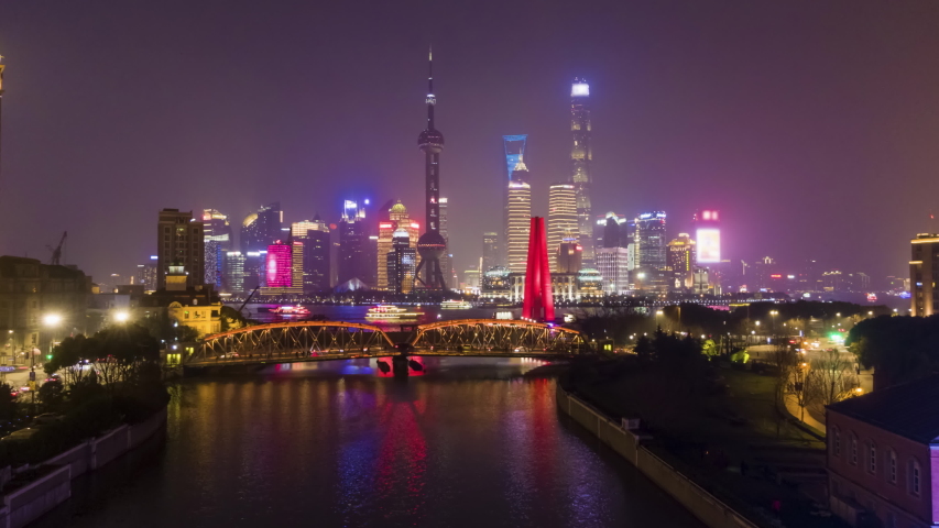 Shanghai Skyline at Night. Urban Lujiazui District, Huangpu River and Waibaidu Bridge. China. Aerial Hyper Lapse, Time Lapse. Drone is Flying Upwards Royalty-Free Stock Footage #1032021494