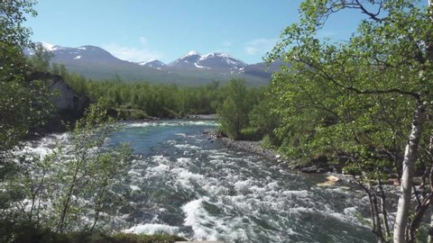 The flowing Abiskojakka river in Abisko National Park on the Kungsleden trail in northern Sweden