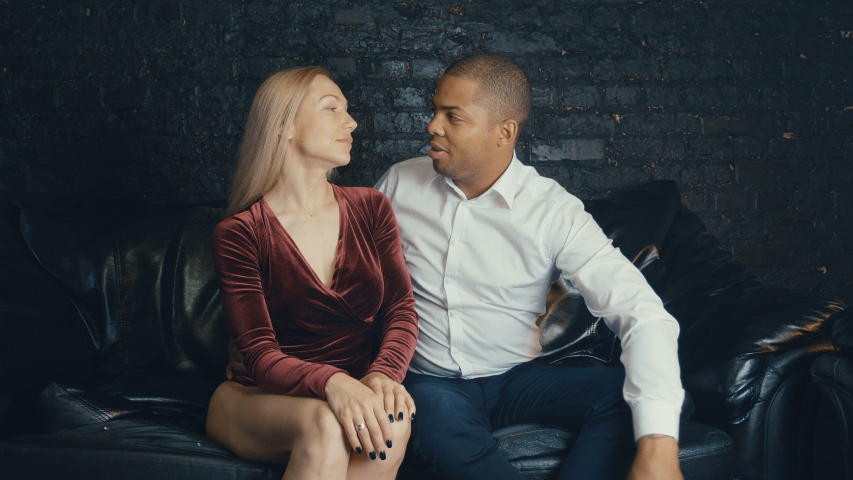 Multiracial couple in love on a date flirts with each other