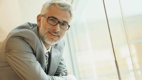 Smiling mature businessman looking into camera