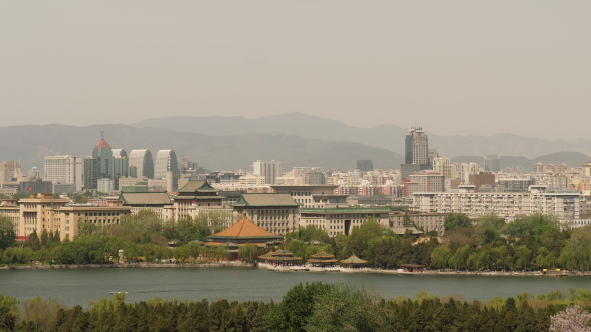 Beijing cityscape, pan across lake Qianhai and the city.