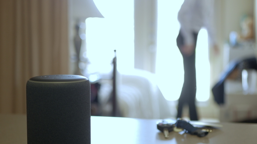 Smart Home Device, Man Getting Ready For Work In The Background. Royalty-Free Stock Footage #1032040115