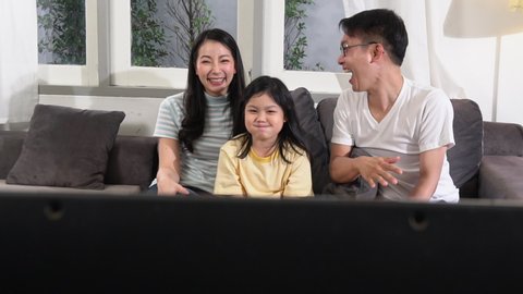 Happy Asian family lifestyle enjoy watching TV at home
