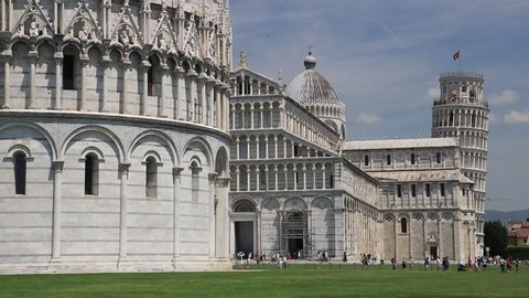 Pisa, Tuscany, Italy. 06/21/2019. Piazza dei miracoli of Pisa. Cathedral, leaning tower of the Tuscan city. Blue sky with clouds.
