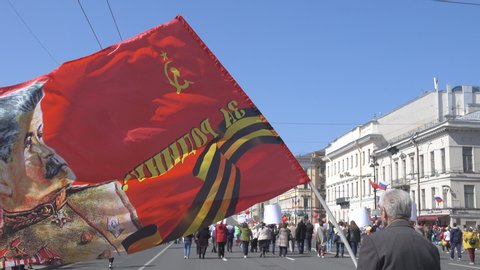 Russia, St. Petersburg - may 1, 2019: May day demonstration. Elderly man carries banner with Stalin portrait on which written: for homeland, for Stalin. Modern Stalinism and nostalgia for USSR