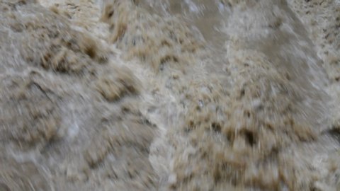 a raging river with dirty water