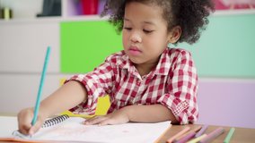 African kids drawing and do homework in classroom, young girl happy funny study and play painting on paper at elementary school. Kid drawing and painting at school concept. - Powered by Shutterstock - Get 15% off with code: PIKWIZARD15
