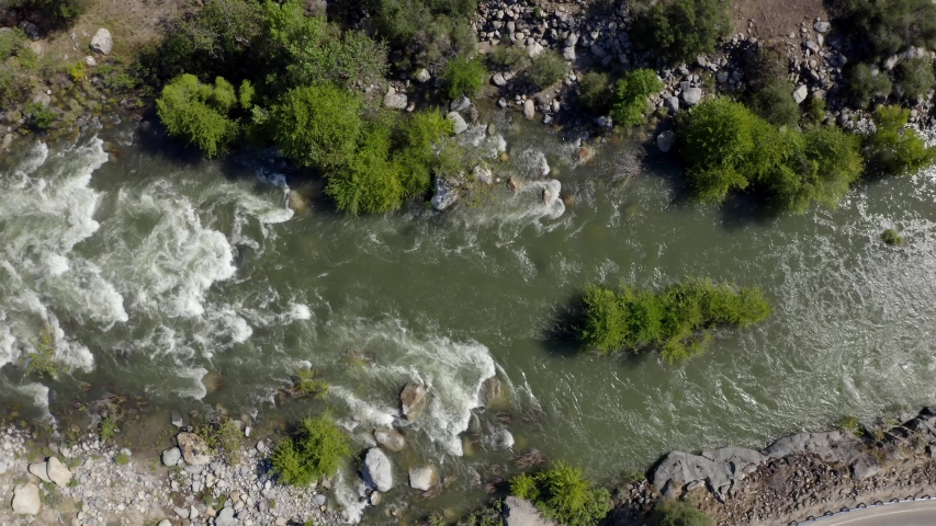 Flying over the Kaweah River whitewater flowing from the snow melt high in the Sequoia National Park through the foothill town of Three Rivers, California.