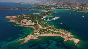 Aerial drone video of famous luxurious Lemos peninsula in Vouliagemeni area with iconic celebrity sandy beach of Asteras, Athens riviera, Glyfada, Attica, Greece