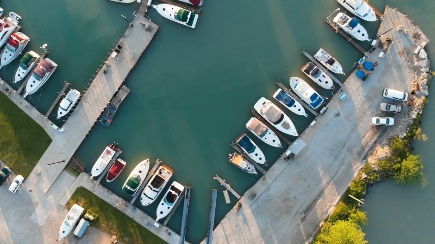 Fly over aerial view of the Michigan lake shore line, pier, yacht club, boats, summer, sunny morning