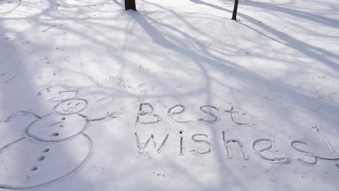 The inscription best wishes on snow.	Shooting in the winter.