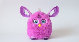 Purple toy bunny figure ears eyes are moving interesting different different alternative video 4K shots stands toy on white background buy moving. 