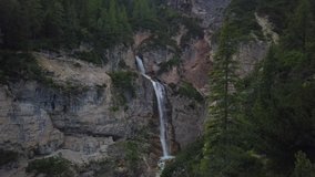 Drone aerial video of wonderful waterfall in Cortina D'Ampezzo Park into Dolomites area.