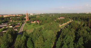 4K aerial summer morning high quality video footage of red brick Gefsimanskiy skit grand cathedral church with golden cupolas in small vintage town Sergiev Posad in Moscow Oblast in central Russia