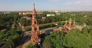 4K aerial summer morning high quality video footage of red brick Gefsimanskiy skit grand cathedral church with golden cupolas in small vintage town Sergiev Posad in Moscow Oblast in central Russia