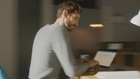 Professional Creative Man Sitting at His Desk in Home Office Studio Working on a Laptop Writes down Notes. Energetic Fast Paced Time-Lapse Fast forward Movement. 360 Degree Tracking Arc Shot - Powered by Shutterstock - Get 15% off with code: PIKWIZARD15