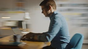 Professional Creative Man Sitting at His Desk in Home Office Studio Working on a Laptop Writes down Notes. Energetic Fast Paced Time-Lapse Fast forward Movement. 360 Degree Tracking Arc Shot - Powered by Shutterstock - Get 15% off with code: PIKWIZARD15