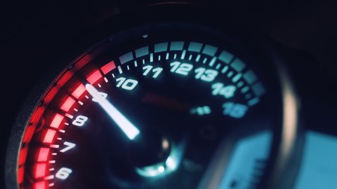 Close-up arrow speedometer of sports bike at high speed. Motorcycle dashboard. Racing in the night city. Night rider.