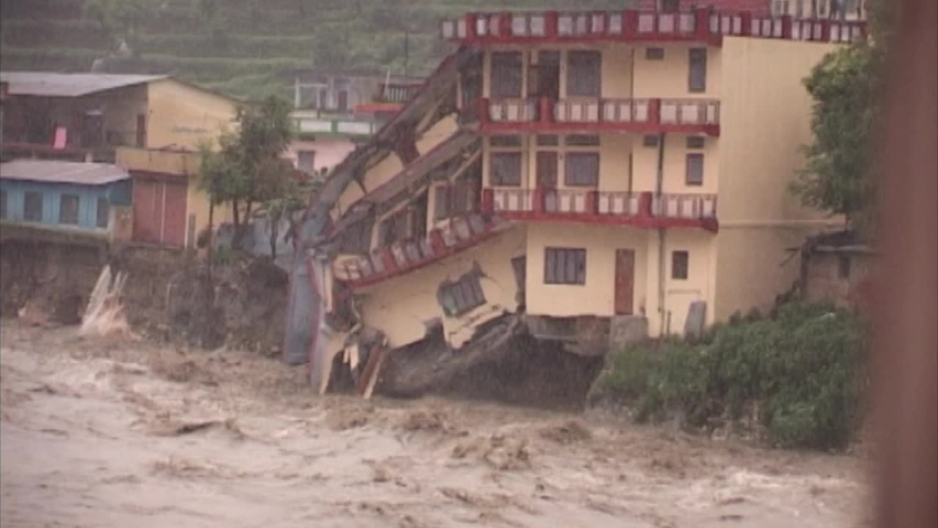 landslide, flood, cloudburst in india 2013 , killed six to seven thousand pilgrims . Three story building collapsed in Ganga river.  Royalty-Free Stock Footage #1032130901