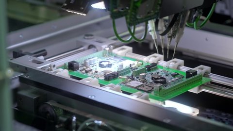 Electronic circuit board production. Automated Circut Board machine Produces Printed digital electronic board. Electronics contract manufacturing. Manufacture of electronic chips. High-tech