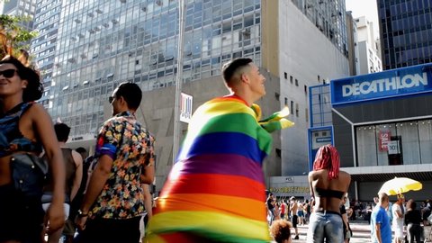 Sao Paulo / Brazil - June 23 2019: Sao Paulo LGBT Pride Parade with LGBT flags, crowd, and couples. 