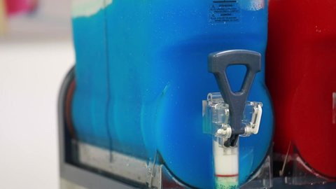 Close up blue slushy machine tap outlet, blending liquid
