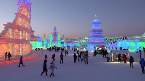 HARBIN, CHINA – JANUARY 2019: People visit illuminated ice palaces and sculptures at famous Harbin ice and snow festival in China