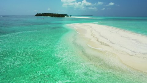 aerial drone shot above sandbank In San Blas Archipelago approaching Remote Uninhabited Tropical Island which is surrounded by small boats