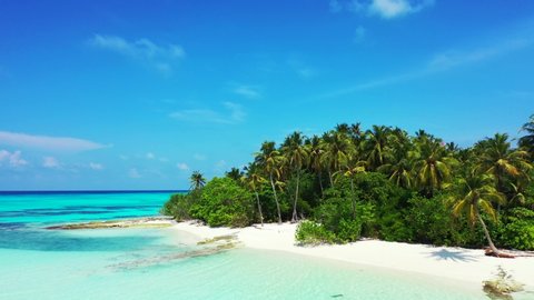drone parallax shot of beautiful Remote Uninhabited Tropical Island In San Blas Archipelago, with palm trees and white sand beach