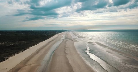 Aerial panoramic view of sea waves, beach and sand dunes. 4K