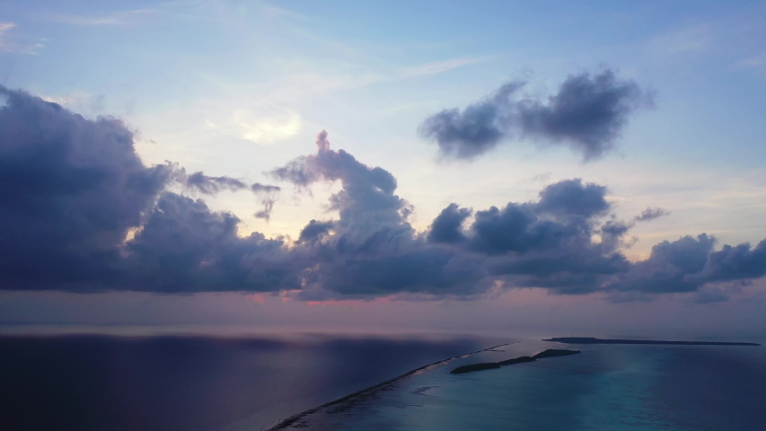 A dramatic sky just after sunset above the Caribbean Sea. Purple and blueish light. Wide angle, static
