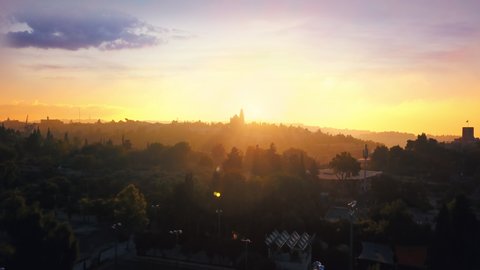 Aerial drone panoramic shot of a sunrise in the old city of Jerusalem in Israel including Jewish, Christian, Armenian, and Muslim (Arab) temples. Jesus Christ.