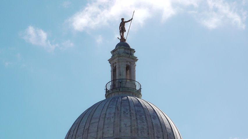 The Independent Man gold statue sits atop the Rhode Island State Capitol building in Providence, RI. Nice blue sky.