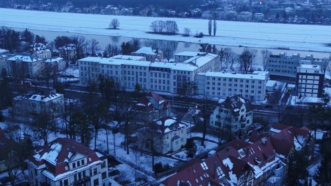 Aerial view of the Radeberger suburb in Dresden. The prefabricated buildings and family houses on the Elbe are dipped in a snowy winter night
