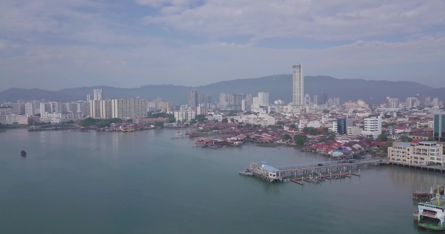Aerial view of George Town, Clan Jetties, and boats along the waterfront of George Town, Penang, Malaysia, represents a unique settlement by Chinese immigrants with boats during morning.