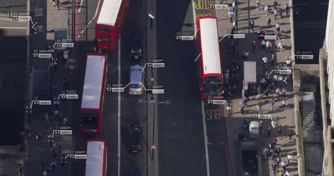 Aerial view of commuters walking near London Bridge. Facial recognition interface showing personal data for each person. Surveillance concept. Artificial intelligence. Shot on Red Weapon 8K.