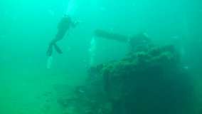 Wreck: an underwater video operator surveys a sunken warship.