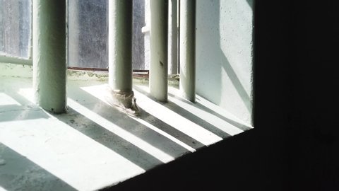Tracking past shadows of bars on a prison cell window