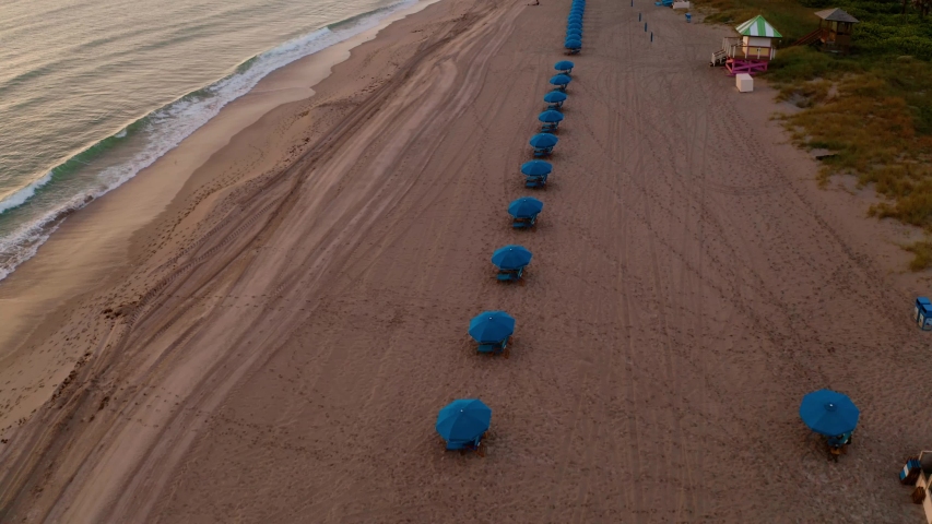 Beautiful aerial shot of the beach right after sunset and the chair setup.