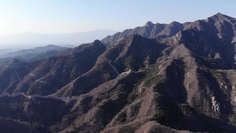 Big mountains at Badaling, Great Wall of China looks like small stony line running over range, aerial view from height