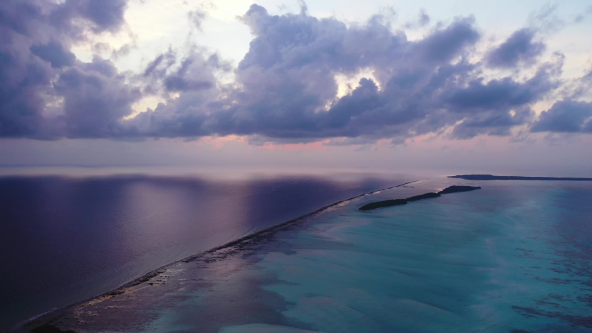 purple blueish light and a dramatic sky Just After Sunset aerial drone shot of Coral Reef In The Caribbean Sea.