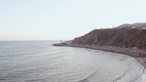 Aerial drone shot, over Malibu beach Pacific Coast Highway with traffic of cars