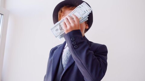 Funny Child Businessman Sniff Money Role Play. Cute Caucasian Kid Act Boss Little Boy Dressed Classical Suit Hat Head Grown-up Occupation Game American Dollars Adult Life Parody Job Concept