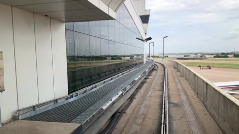 Grapevine, TX, USA - May 22, 2019 :  View from transfer train inside Dallas-Ft. Worth International Airport around American Airlines terminals in Grapevine, Texas.
