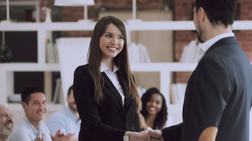 Staff reward concept, happy female employee get promoted by boss manager handshake praise proud excited businesswoman best worker congratulate with recognition at work thank for team support applause Royalty-Free Stock Footage #1032278294