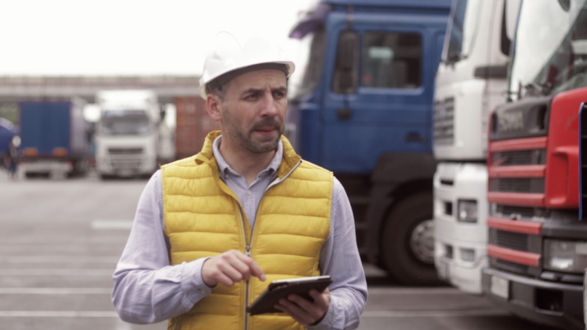 Trailer driver with hard hat and safety vest. Close up portrait of worker Royalty-Free Stock Footage #1032281636
