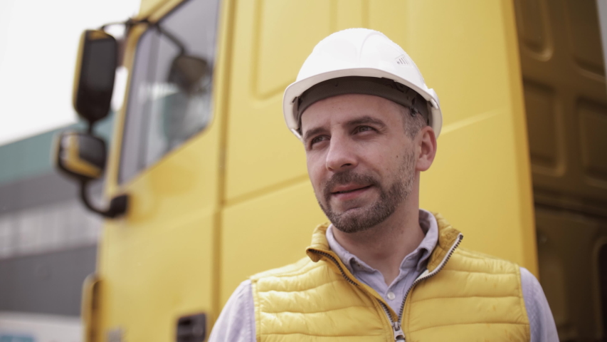 Trailer driver with hard hat and safety vest. Close up portrait of worker Royalty-Free Stock Footage #1032281669