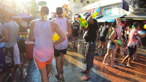 Bangkok, Thailand-April 13, 2019: Locals and tourists celebrate Songkran Festival, Traditional Thai New Year. People play water, and use water guns to enjoy the festival.