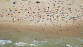 Crowded public beach with colourful umbrellas, Aerial footage.