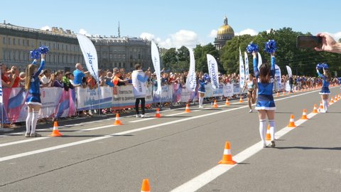 30 June 2019 St. Petersburg: strong girl runner crosses the finish line of the marathon distance, wins the international marathon in slow motion